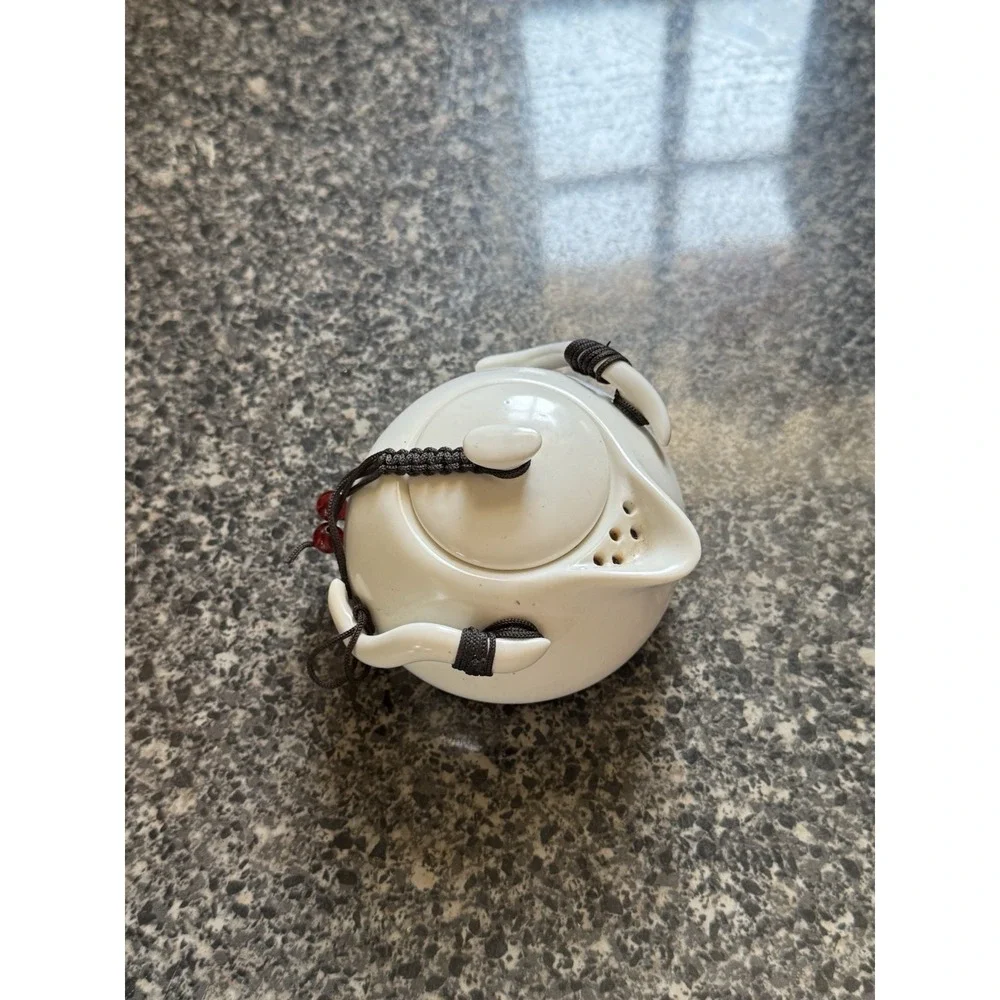 Compact travel tea pot white ceramic with decorative cord